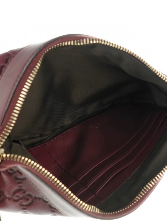 Gucci Monogram burgundy leather clutch bag
