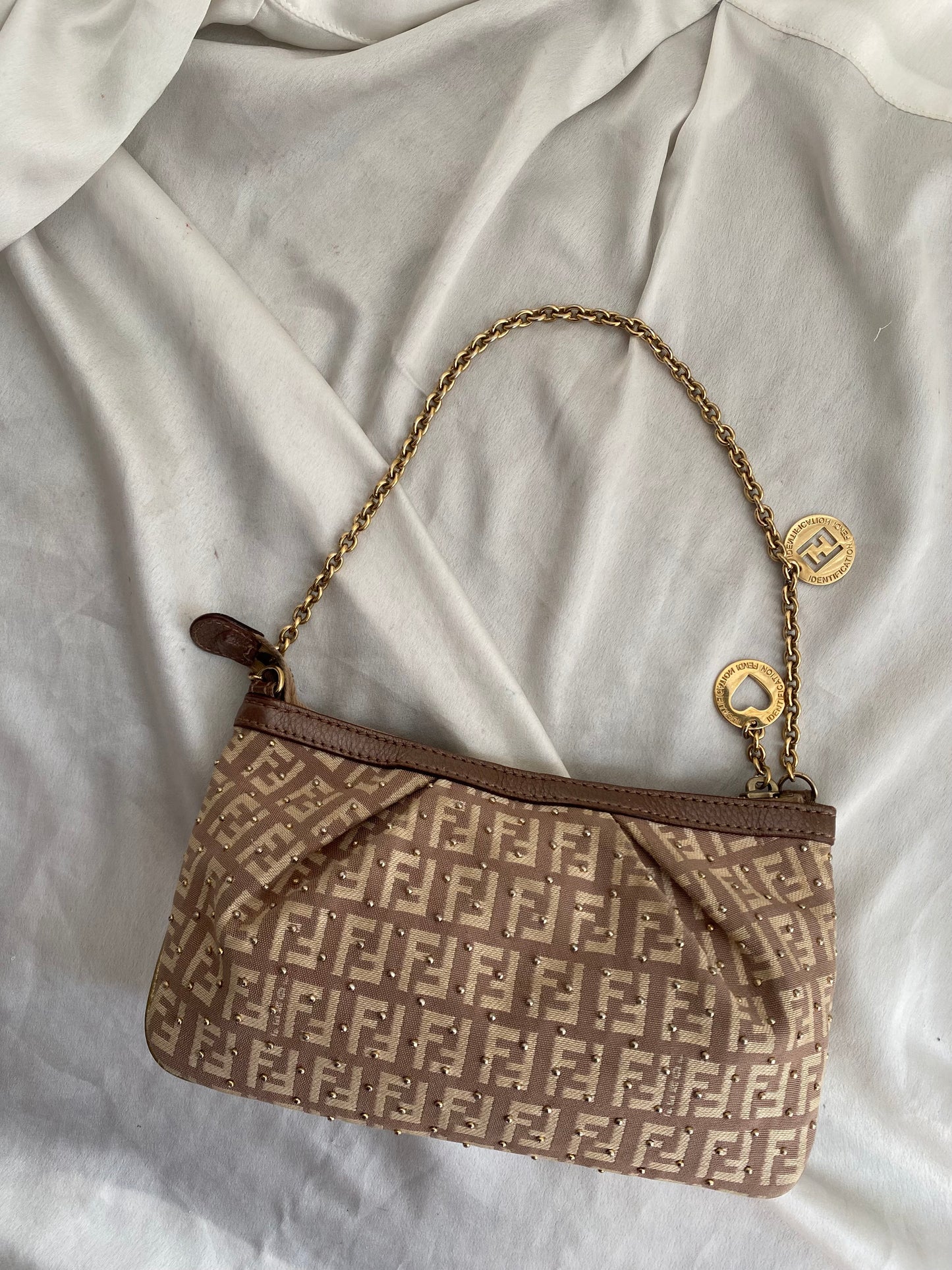 Fendi clutch bag with gold charms and beige zucchini monogram