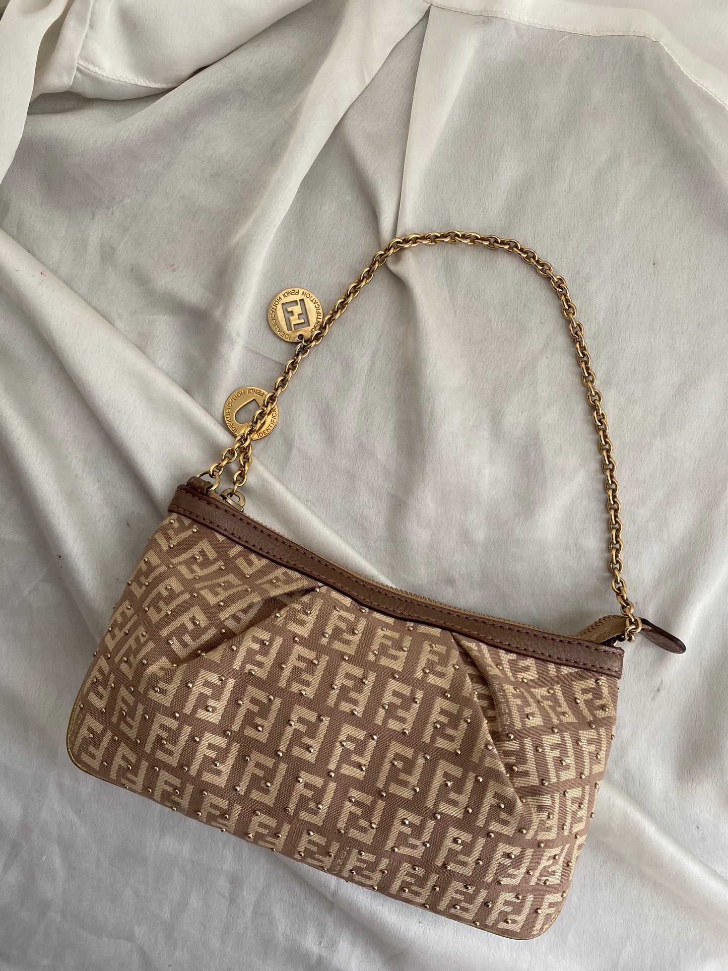 Fendi clutch bag with gold charms and beige zucchini monogram
