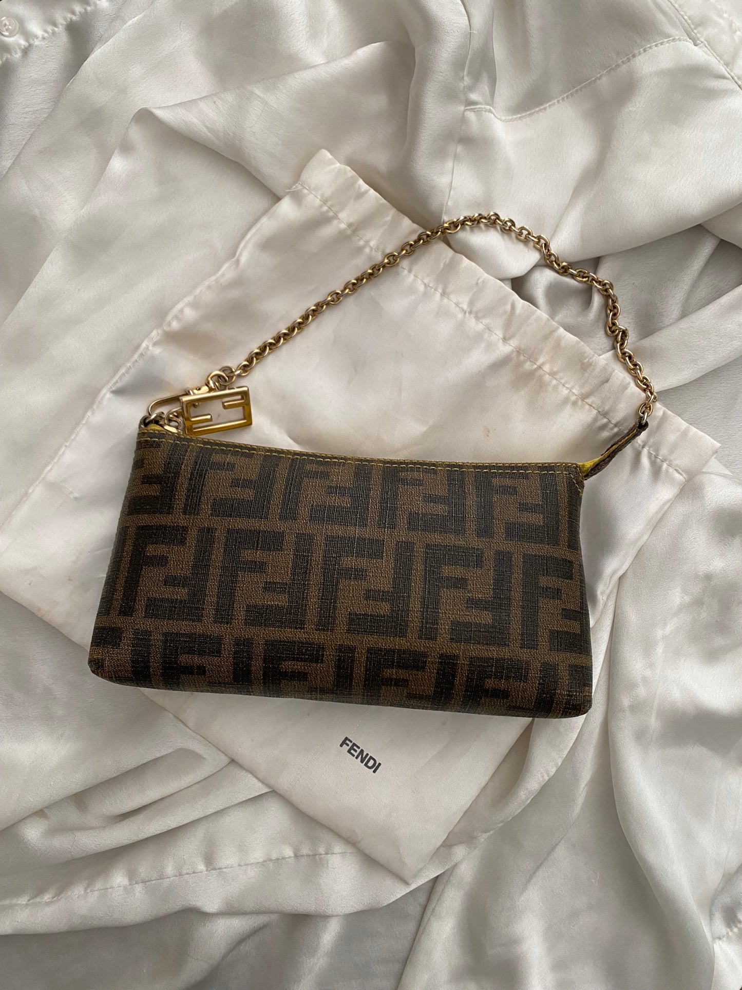 Fendi monogram clutch bag in pumpkin, tobacco, and yellow