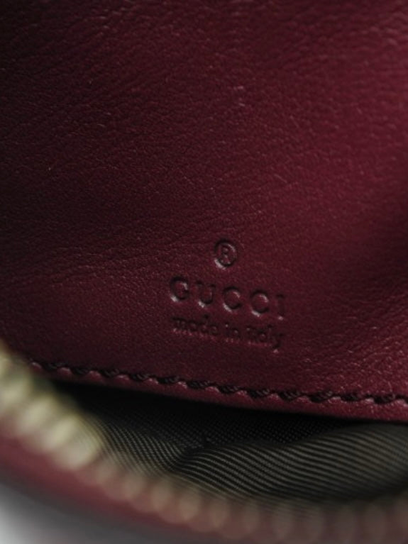 Gucci Monogram burgundy leather clutch bag