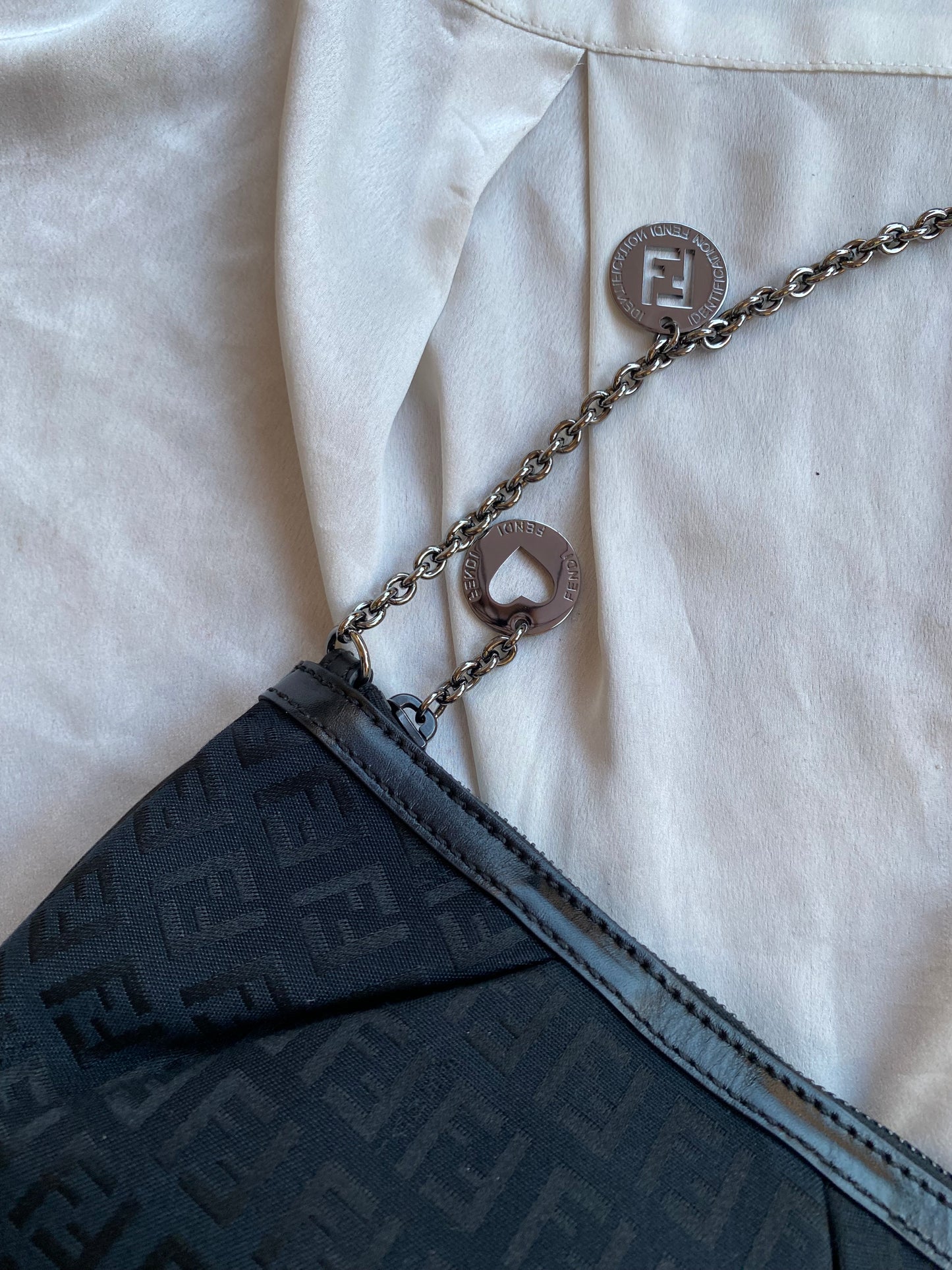 Fendi clutch bag with silver monogram charms and zucchini