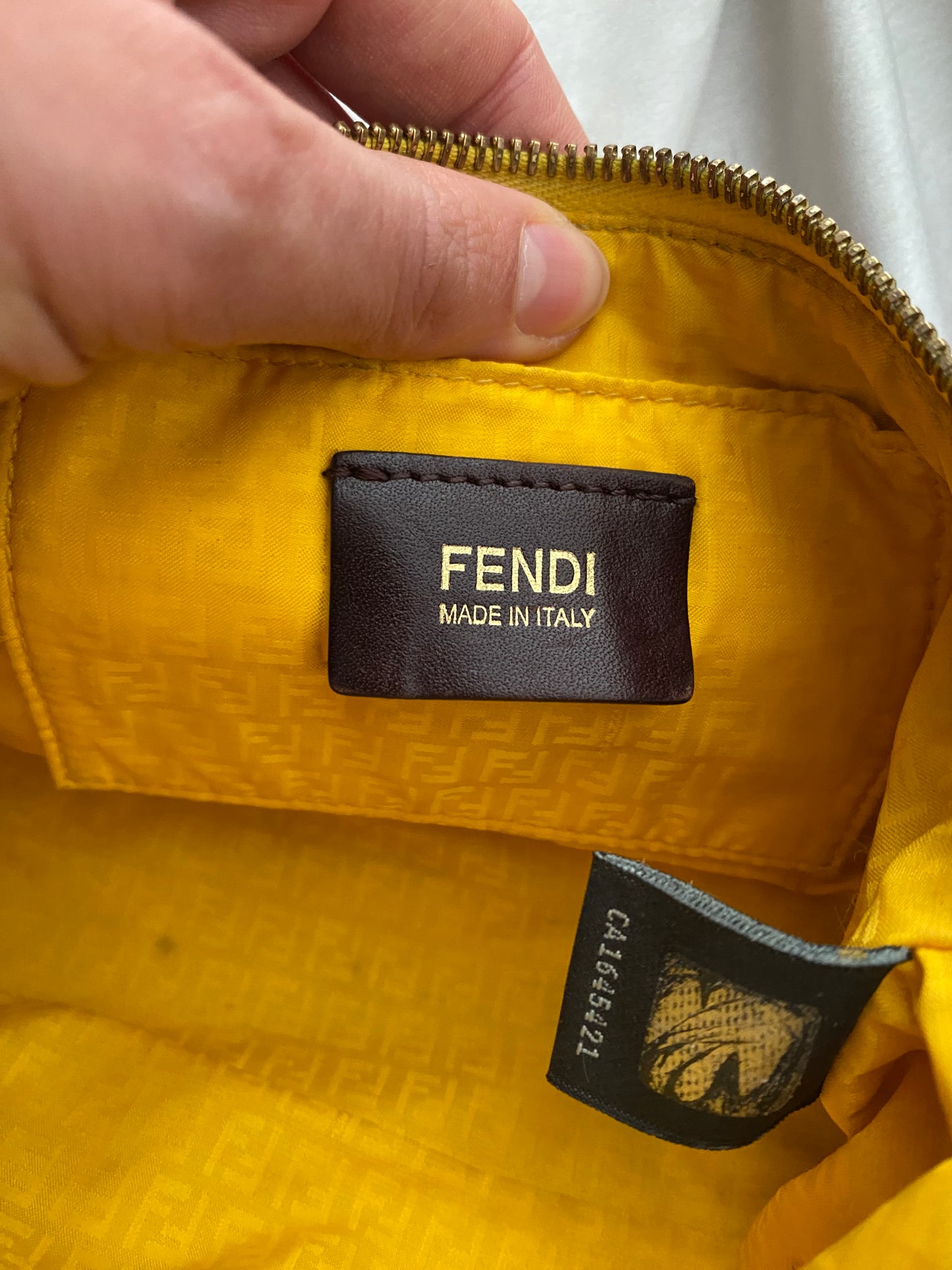 Fendi monogram clutch bag in pumpkin, tobacco, and yellow