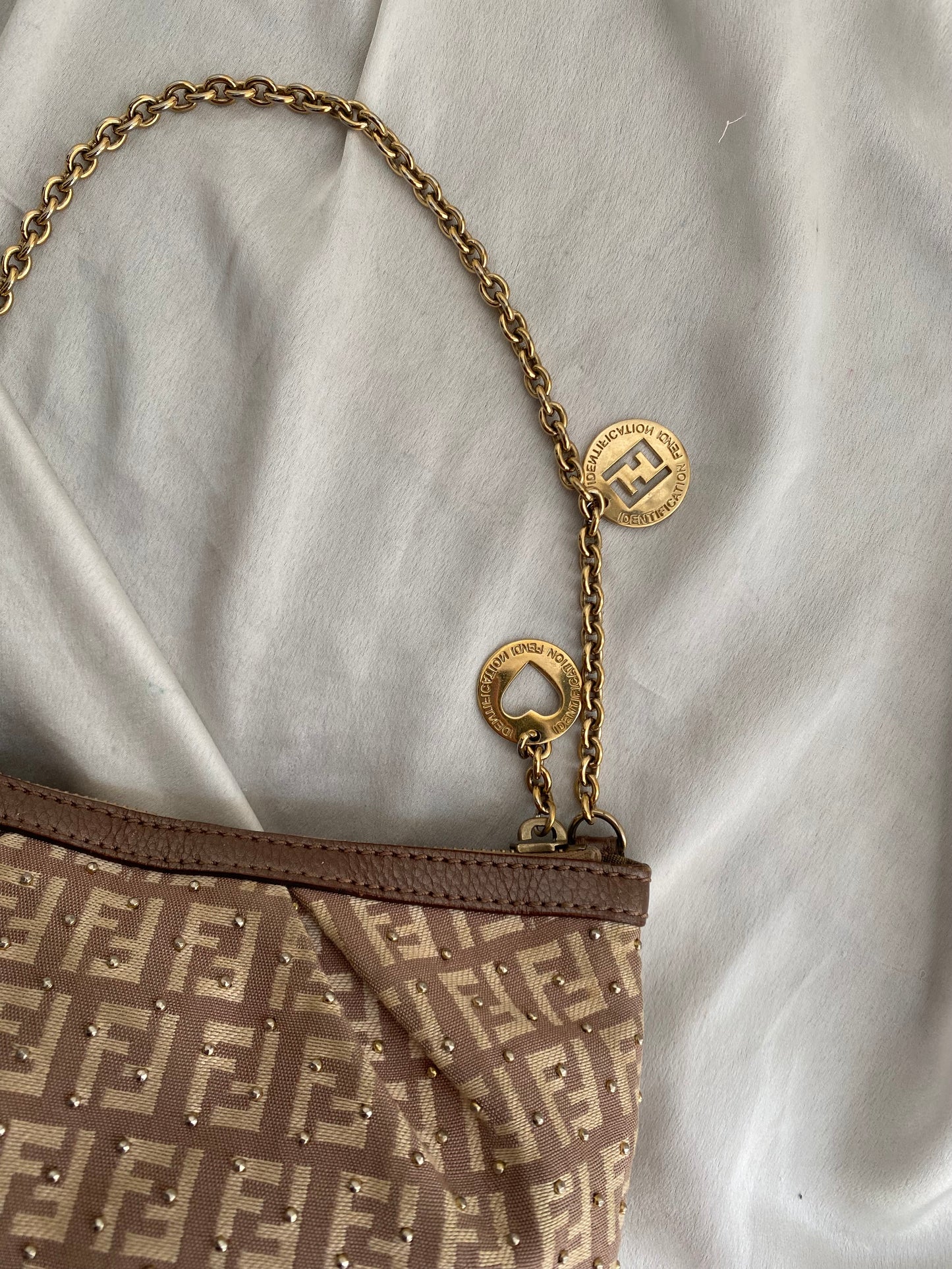 Fendi clutch bag with gold charms and beige zucchini monogram