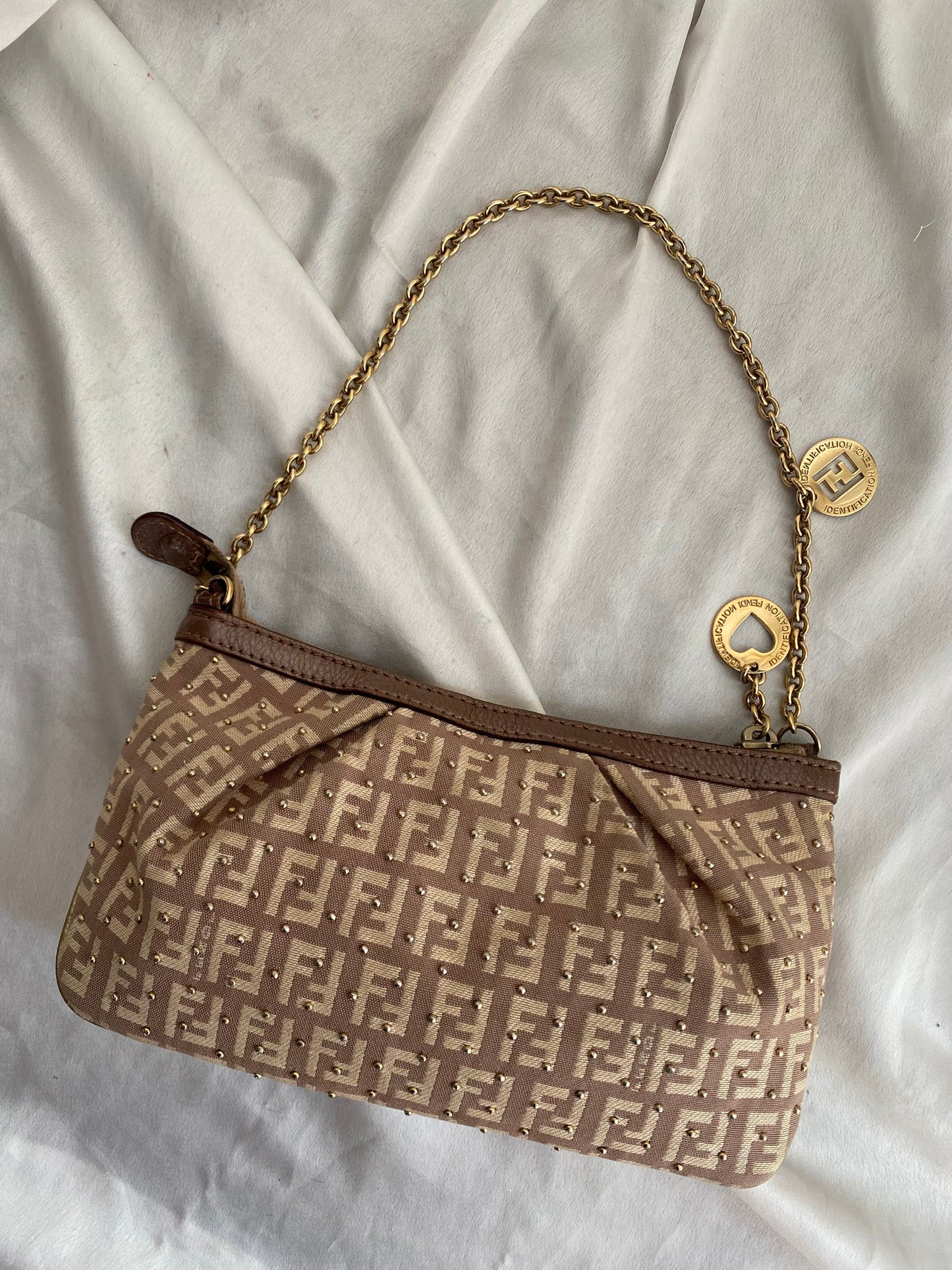 Fendi clutch bag with gold charms and beige zucchini monogram