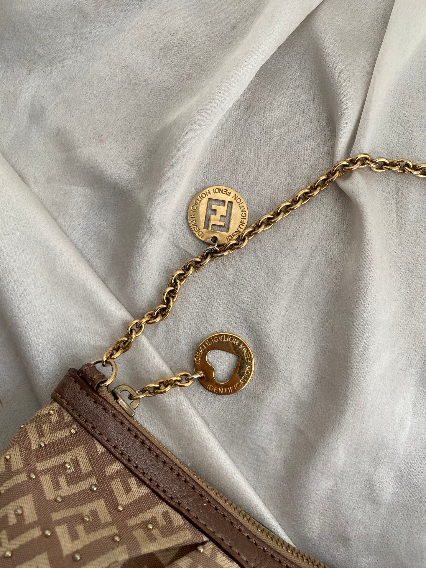 Fendi clutch bag with gold charms and beige zucchini monogram