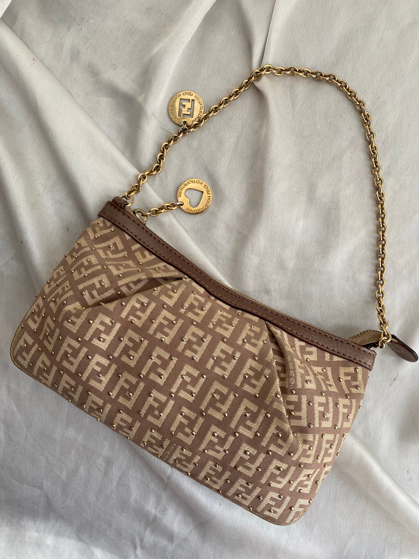 Fendi clutch bag with gold charms and beige zucchini monogram